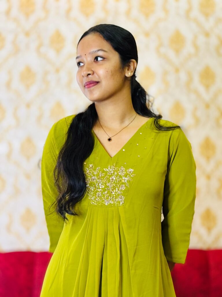 Designer working on custom tailored dresses in Kochi, creating elegant outfits with perfect fit and fine detailing.