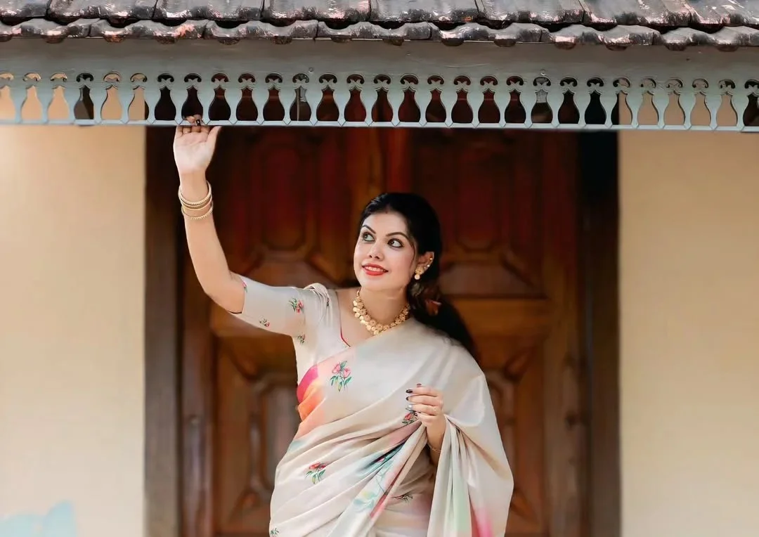 Kerala traditional saree in pastel cream with floral detailing – Janki Design, Kochi.